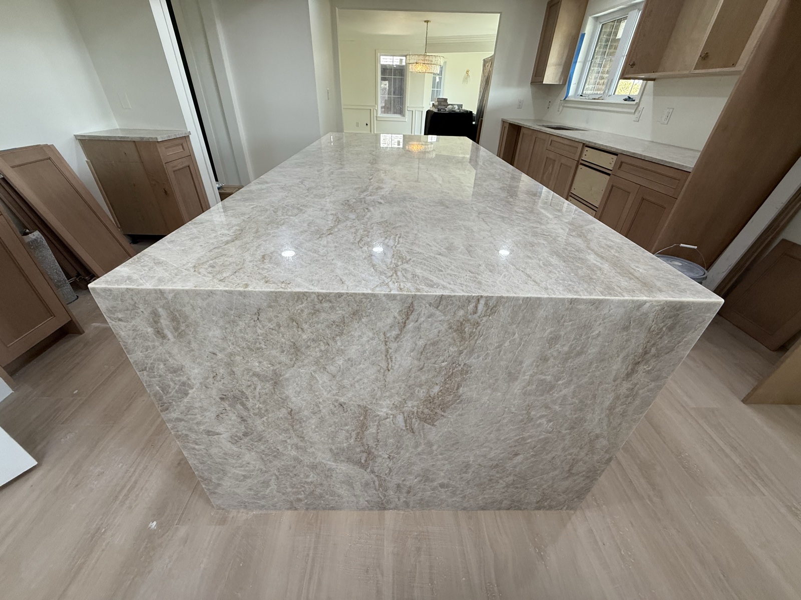 Large quartzite kitchen island with mitered waterfall edge