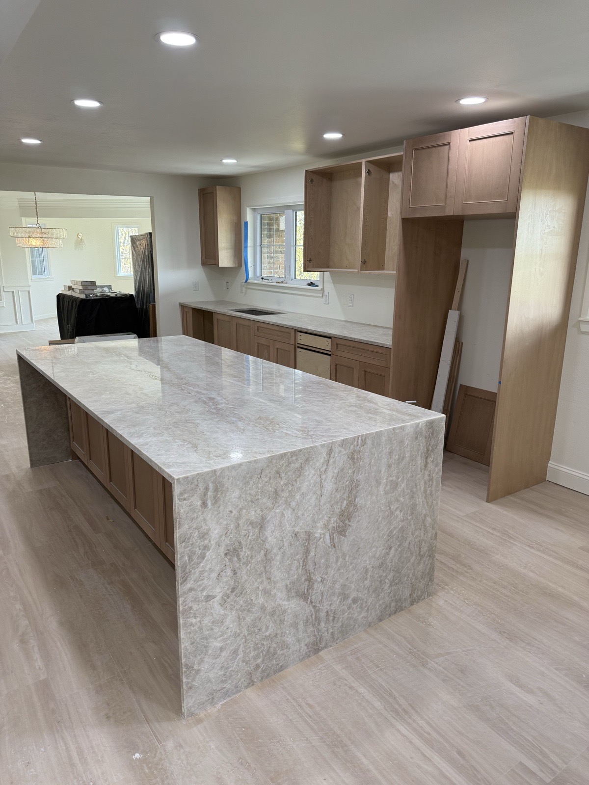 Cream quartzite waterfall island detail with mitered edge