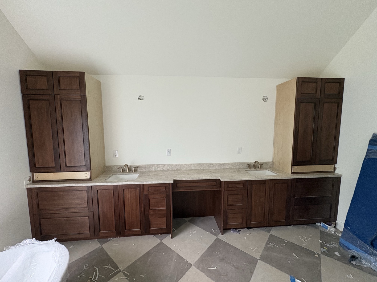 Master bath dual vanity with cream stone tops and dark walnut cabinetry